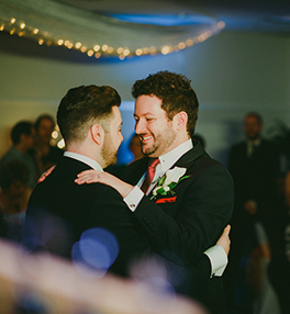 A gay couple dancing.