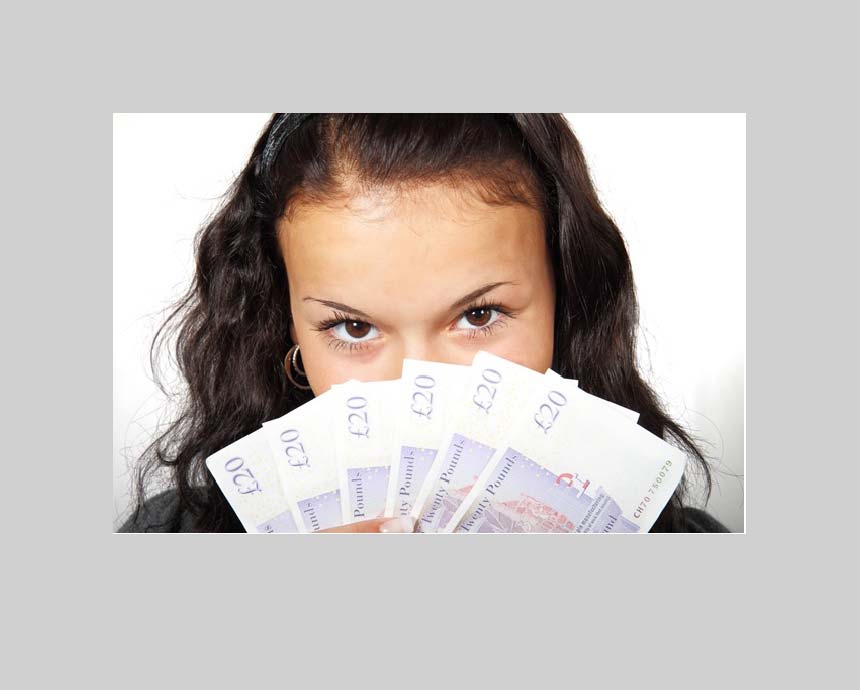 girl holding money behind face