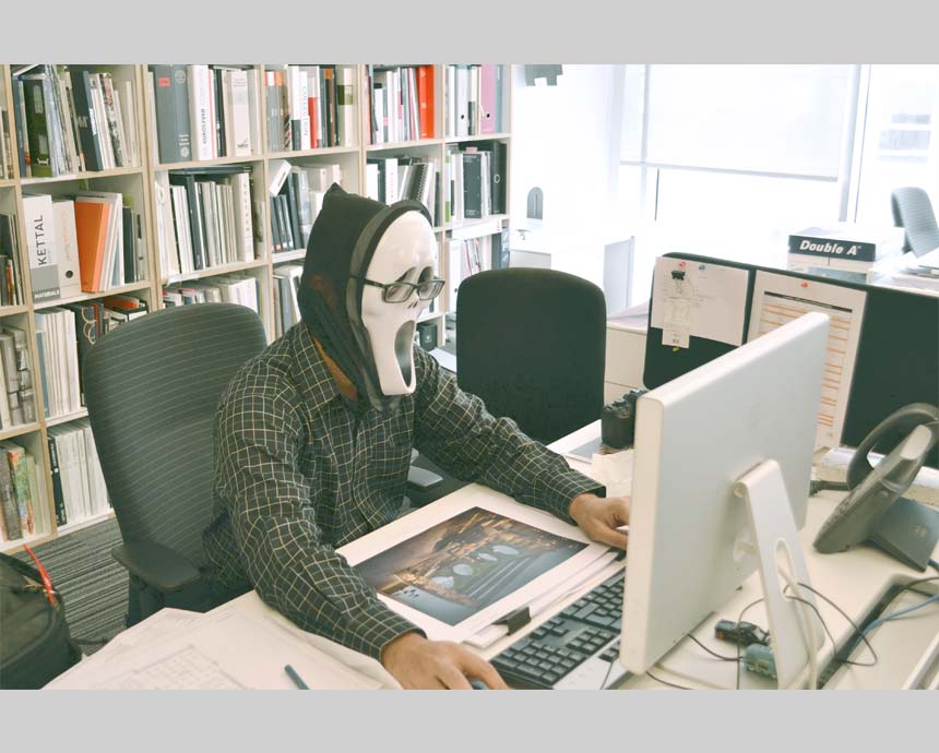 guy on a mask looking at laptop