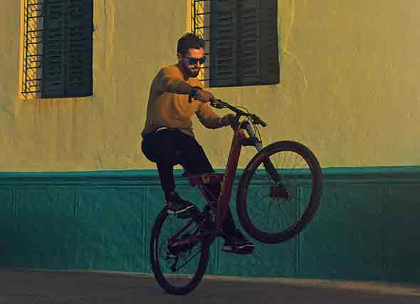 A man doing wheelies on his bike
