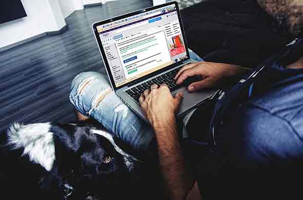 man typing on laptop