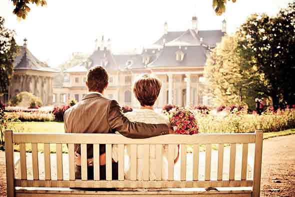 married couple sitting on bench