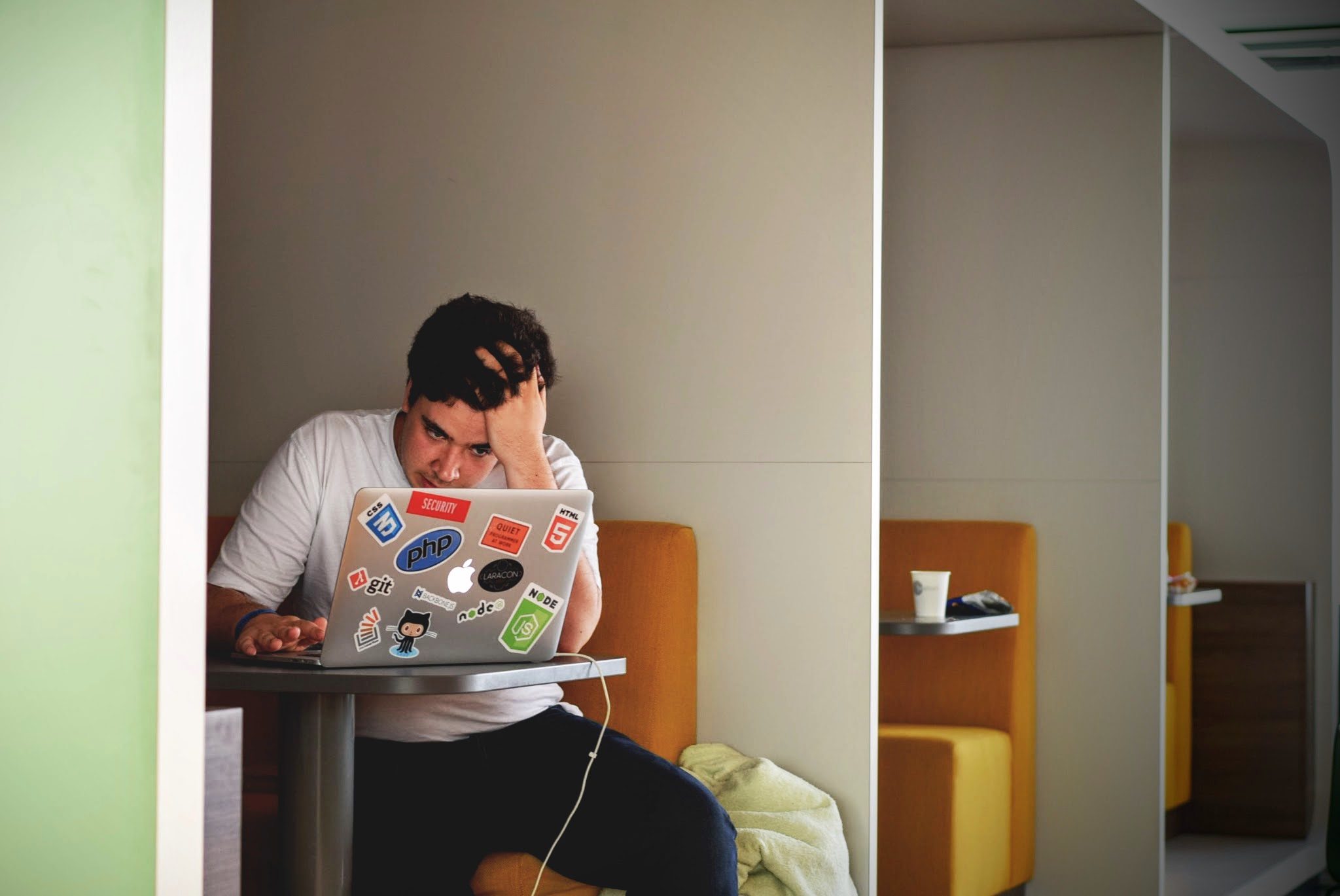 A frustrated man using a computer.