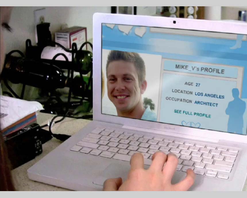 girl’s hand on laptop with a guy’s online profile