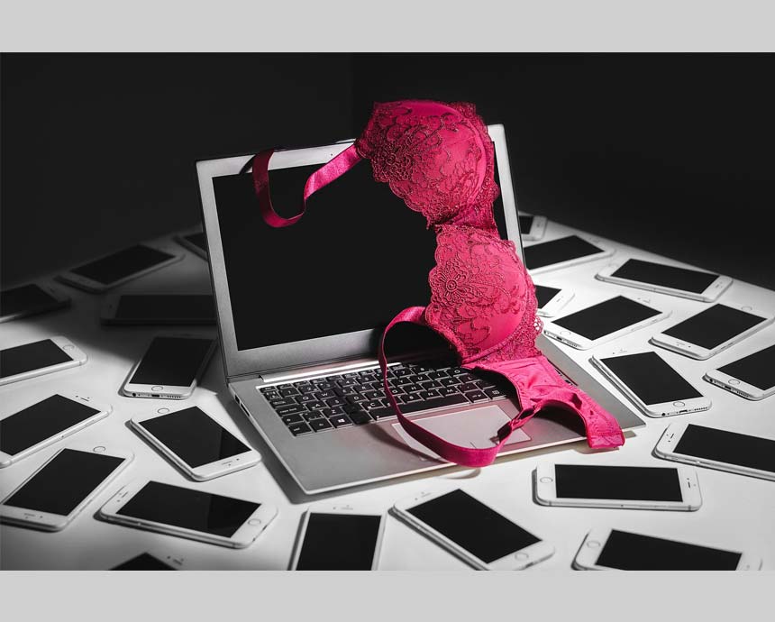 laptop and pink bra surrounded by a lot of phones